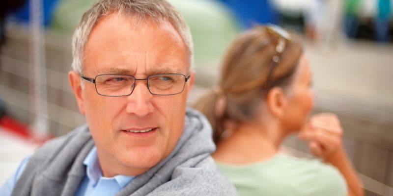 Mature couple facing opposite direction